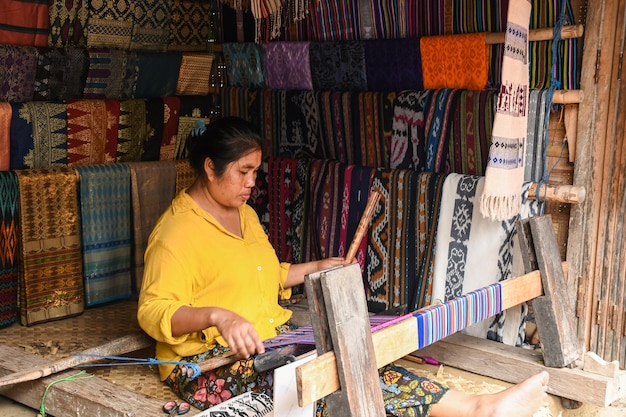 Sasak woman traditionally makes yarn with a spindle wheel at traditional Sasak village, Lombok