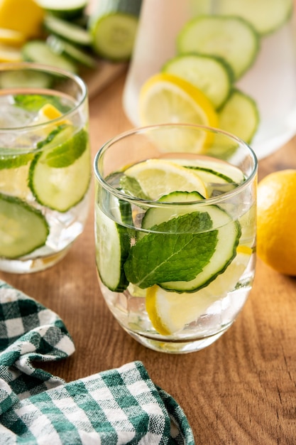 Sassy water or water with cucumber,lemon, ginger and mint on wooden table