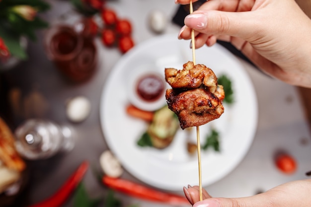 Satay or sate, skewered and grilled meat, served with peanut sauce, cucumber and ketupat, Malaysia or Indonesia food. Chicken's meat. Hot and spicy Malaysian dish, Asian cuisine