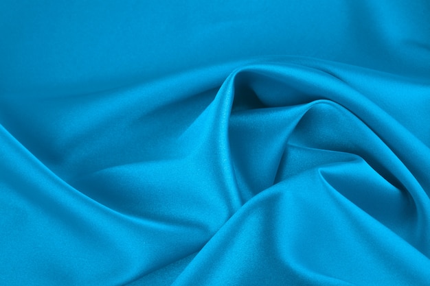 Satin fabric, close-up. Classic blue color, monochrome.