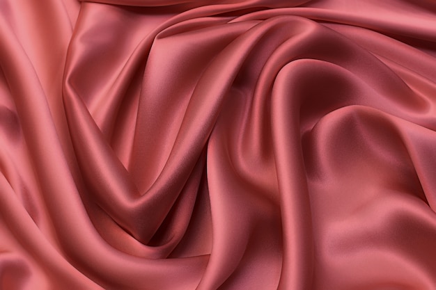 Satin silk fabric in beige-pink color in artistic layout