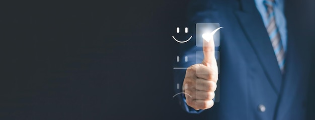 Satisfaction Concept Businessman is touching the virtual screen on the happy Smiley face icon