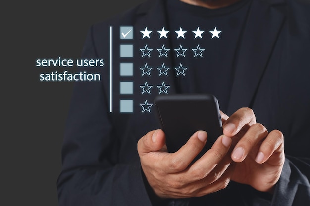 Satisfaction from service users concept businessman using smartphone customer satisfaction check star rating