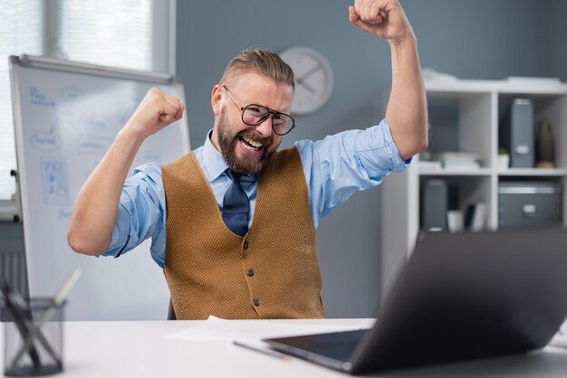 Satisfied businessman with laptop