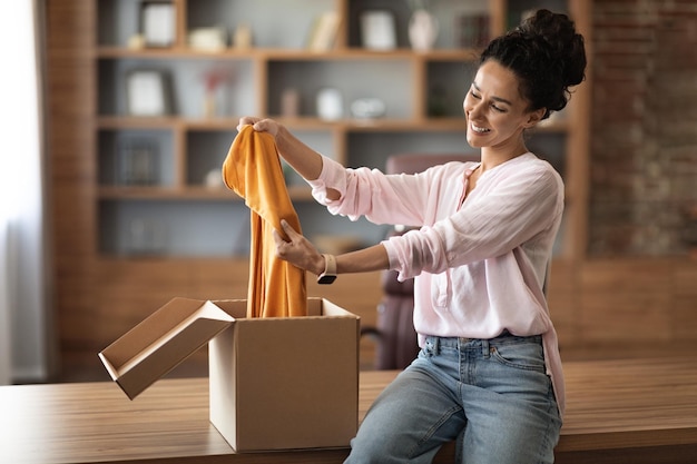 Satisfied customer attractive young woman checking her delivery