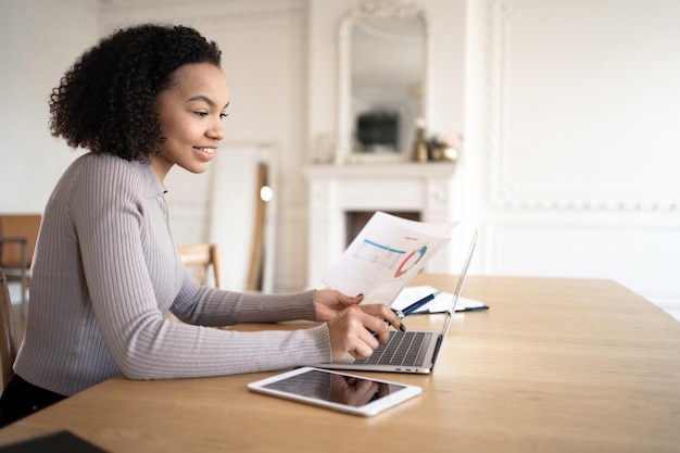 A satisfied designer uses a new laptop for work A female freelancer writes a message 