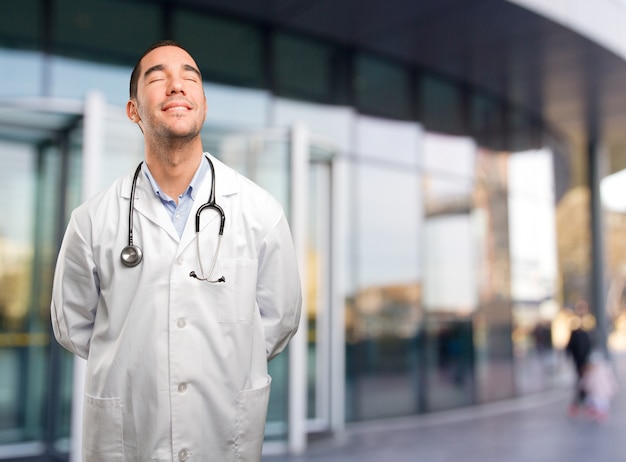 Satisfied young doctor relaxing