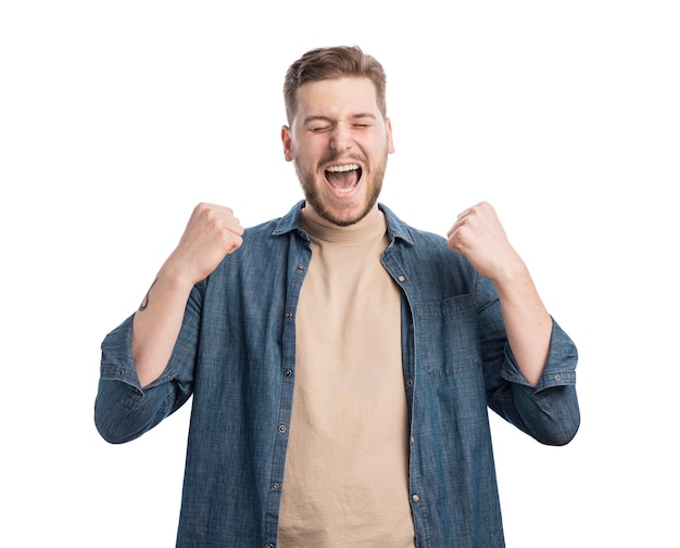 Satisfied young man raising clenched fists