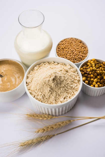 Sattu is a flour, mixture of roasted ground pulses and cereals. Traditional and nutritional food supplement from India. Served over moody background. selective focus