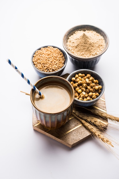 Sattu sharbat is a cooling sweet drink made in summer with roasted black chickpea flour, barley, suger, salt & water. served in a glass. selective focus