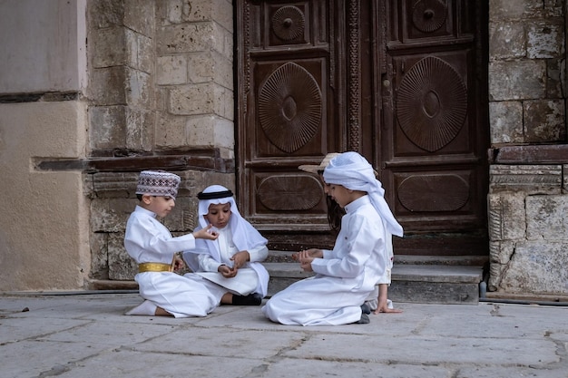 Saudi Arabian kids playing outside the house in Jeddah old town Saudi Srabia