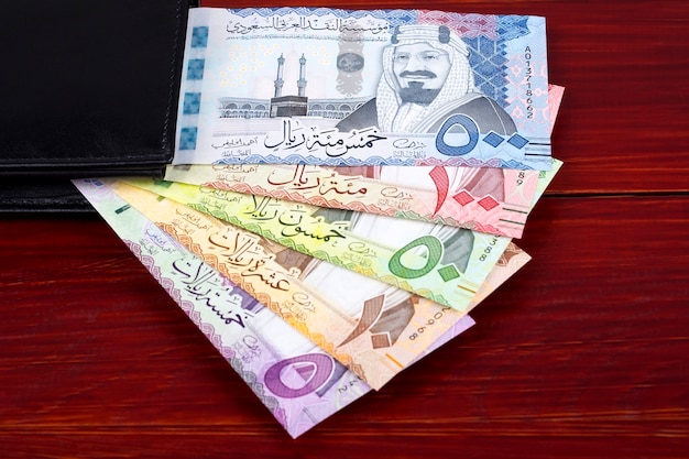 Saudi Riyal banknotes in the black wallet 