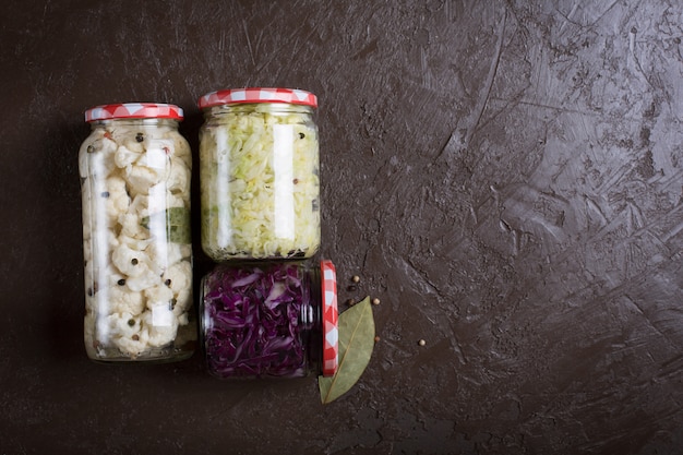 Sauerkraut in a blue bowl on a wooden table. Top view