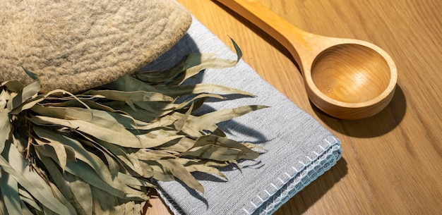 sauna accessories in the steam room. Brush, soap, broom, hat, linen towel. Flat lay. Copy space.