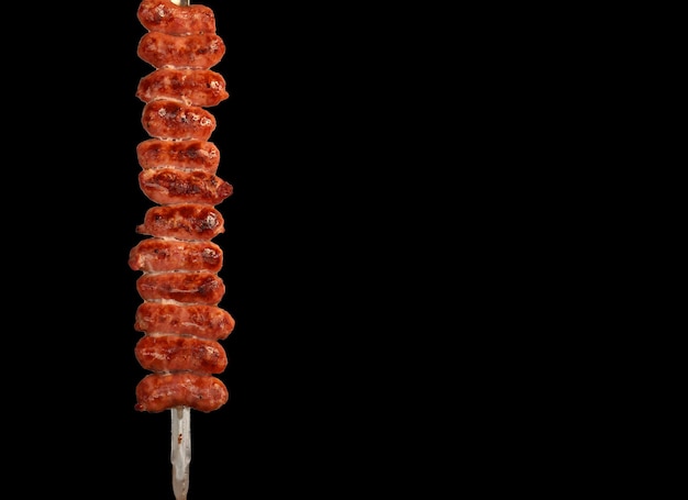 Sausage on skewers on a wooden background copy space