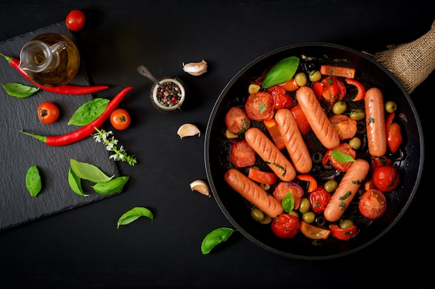 Sausages grilled with vegetables in the Greek style on pan