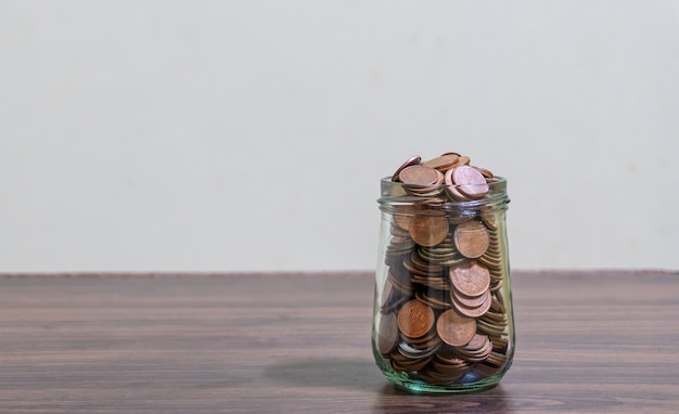 Save money and account banking for finance concept, Coins stack in bottle on blurred background