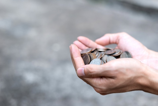  Save money concept with hand holding coins