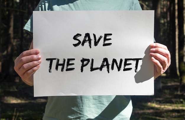 Save the planet text on placard in hands