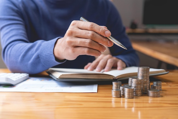 Saving concept the male who is holding a silver pencil counting his money