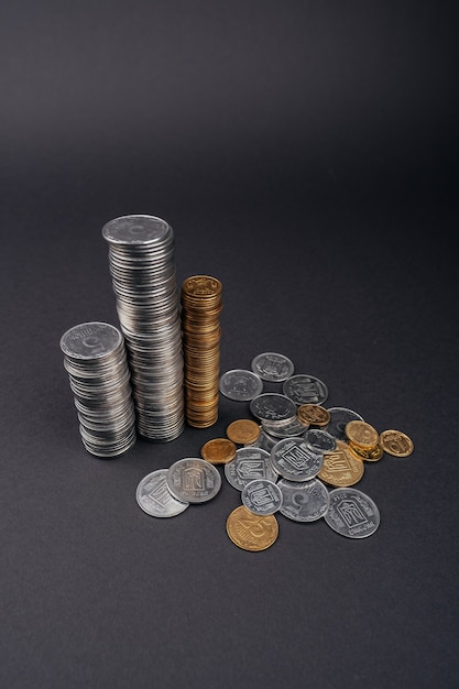 Saving money coin stacks tower dark surface