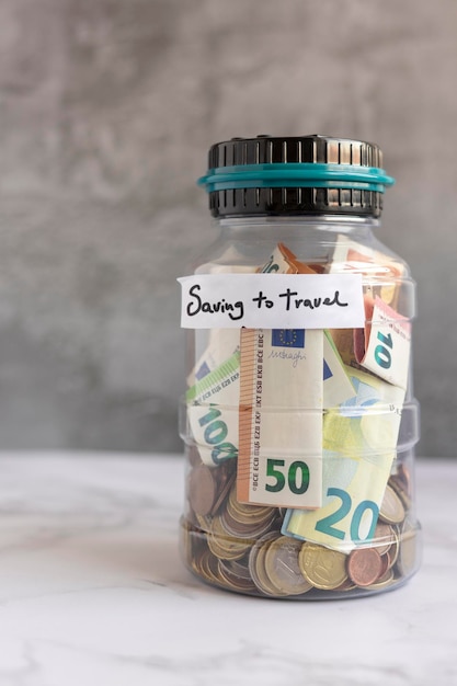 Saving money to travel after the Covid19 in a jar of money Concept of saving Money