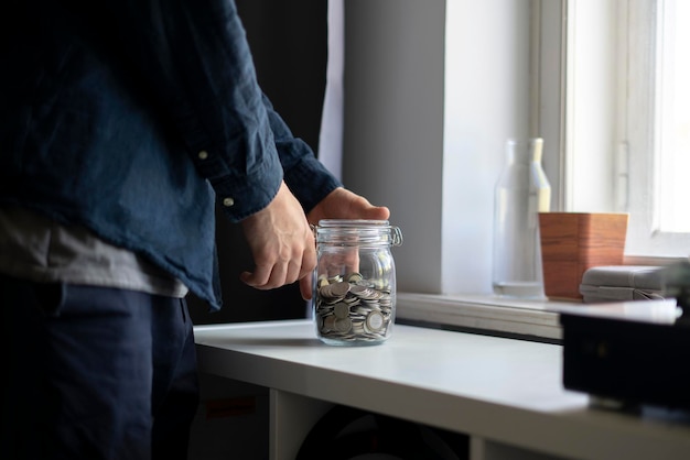 Savings concept holding glass with coins money