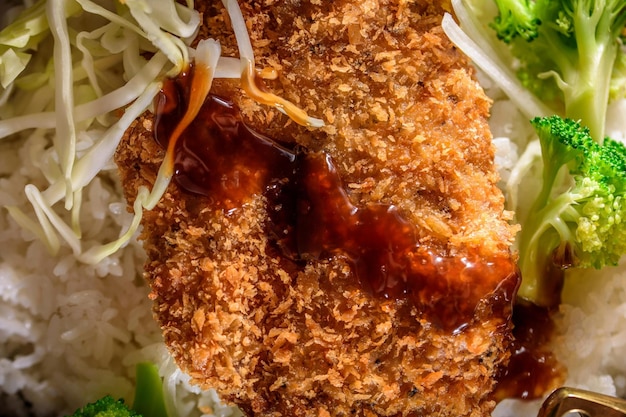 Savory Delights CloseUp of DeepFried Orange Chicken Served on a Bed of Steamed White Rice in 4k