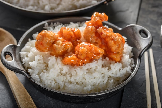 Savory Delights CloseUp of DeepFried Orange Chicken Served on a Bed of Steamed White Rice in 4k