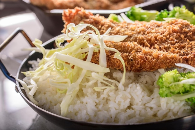 Savory Delights CloseUp of DeepFried Orange Chicken Served on a Bed of Steamed White Rice in 4k