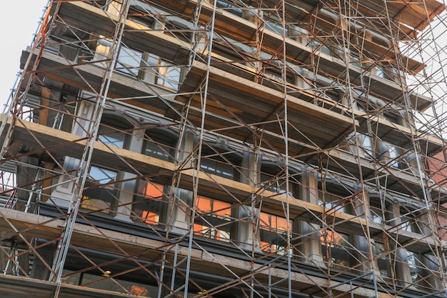 Scaffolding on a building with a window that says, "