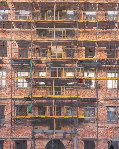 Scaffolding on the facade of the building Exterior finishing works Natural light