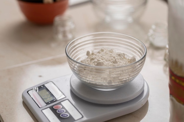 Scale with a bowl with flour in a Mexican kitchen counter to make bread