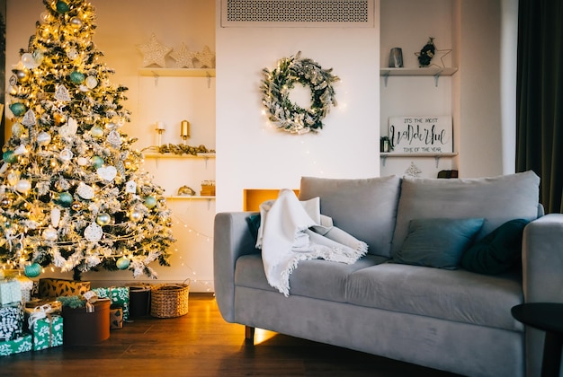 Scandinavian Christmas interior in living room with Christmas tree in the evening.