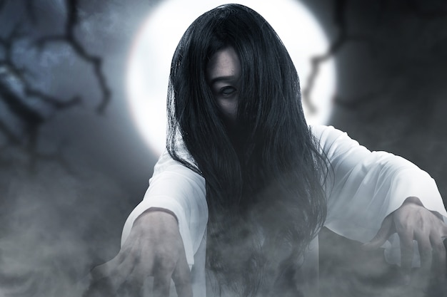 Scary ghost woman standing with night scene background. Halloween concept