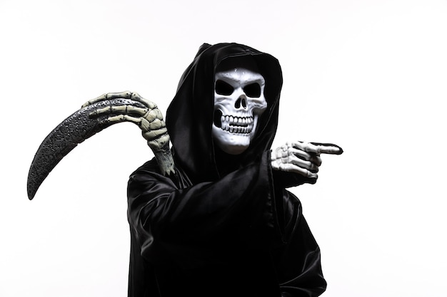 Photo scary grim reaper in black clothes with scythe pointing out on white