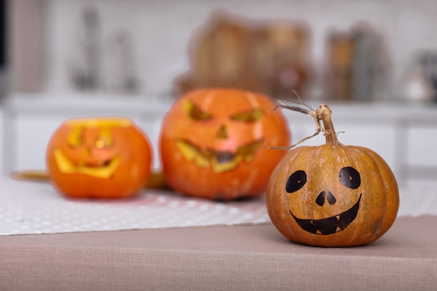 Scary Halloween pumpkins with eyes on the table at home