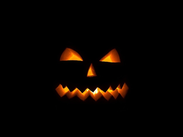 Scary pumpkin smile for Halloween on a black background