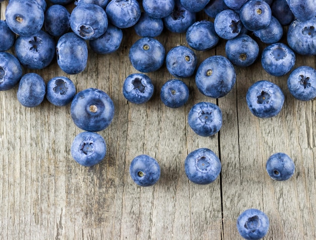 Scattered blueberries on a wooden table