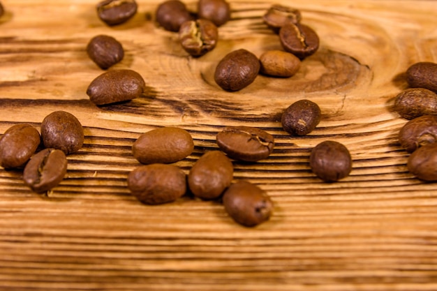 Scattered coffee beans on a wooden table