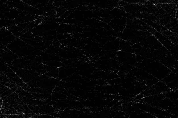 Scattered dust particles and scratches on a black concrete wall surface for texture background