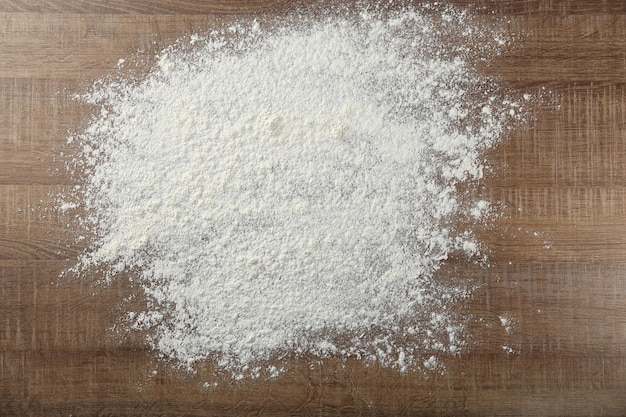 Scattered flour on wooden background