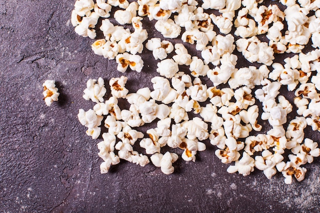 Scattered fresh popcorn on the table, close up top view