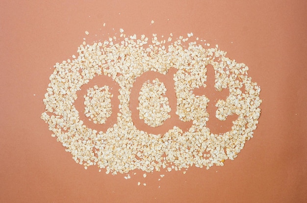 Scattered oatmeal on beige background