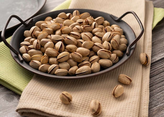 scattered pistachios on a tray on the table