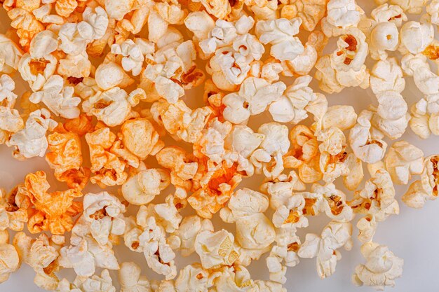 scattered popcorn on a white background closeup