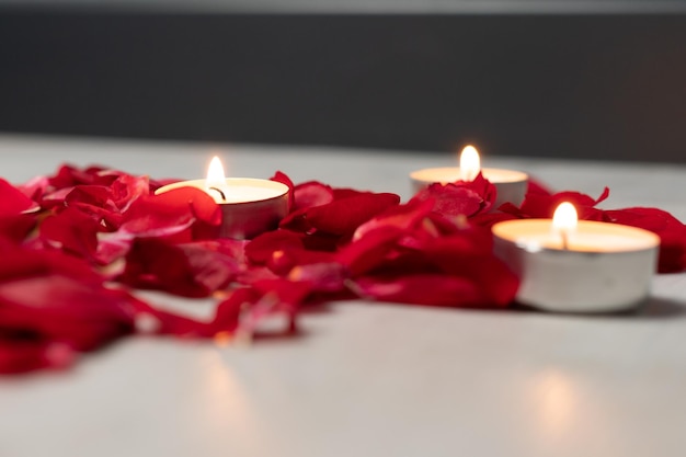 Scattered rose petals and candles aromatic rose fragrance and candle aroma