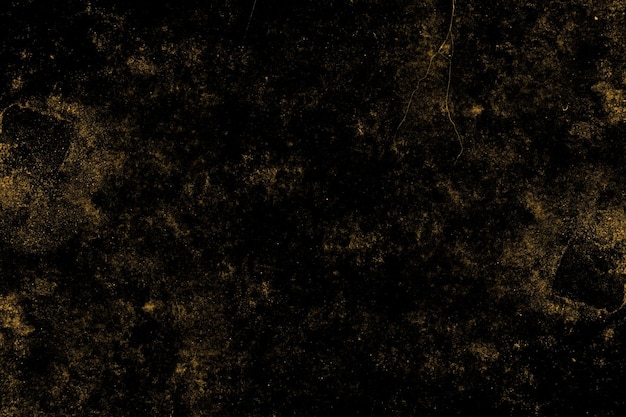 Scattered yellow grunge texture on a dark concrete wall surface