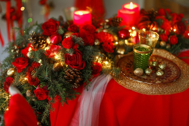 Scenery for christmas red closeup candles on the table and christmas wreaths