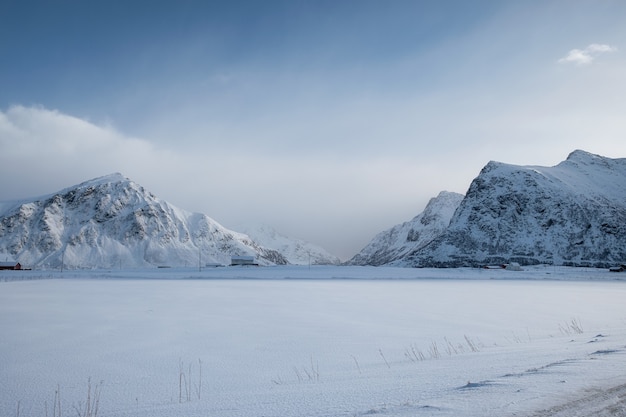 Scenery of snow mountain range with overcast sky in winter at Skagsanden beach